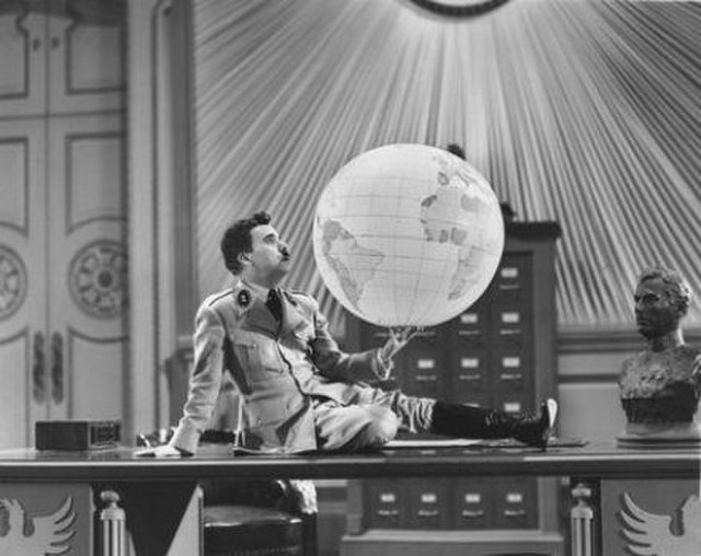 Charlie Chaplin as the dictator playing with the world in The Great Dictator (1940).