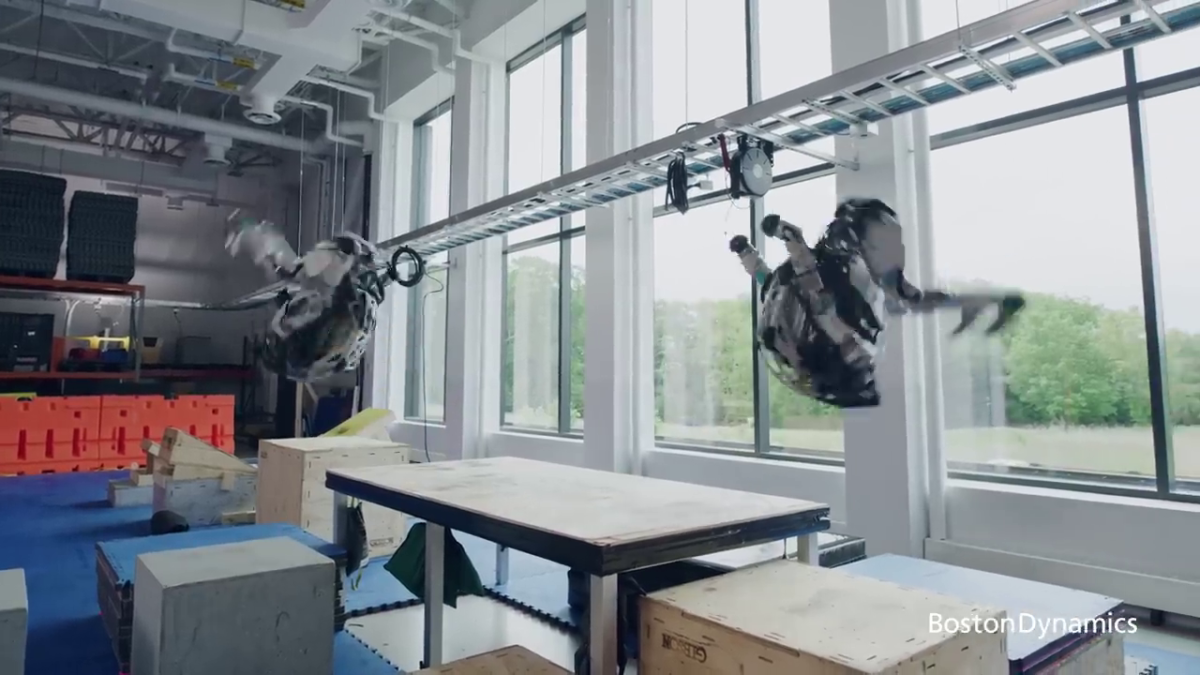 Boston Dynamics' Atlas robots do synchronized back flilps