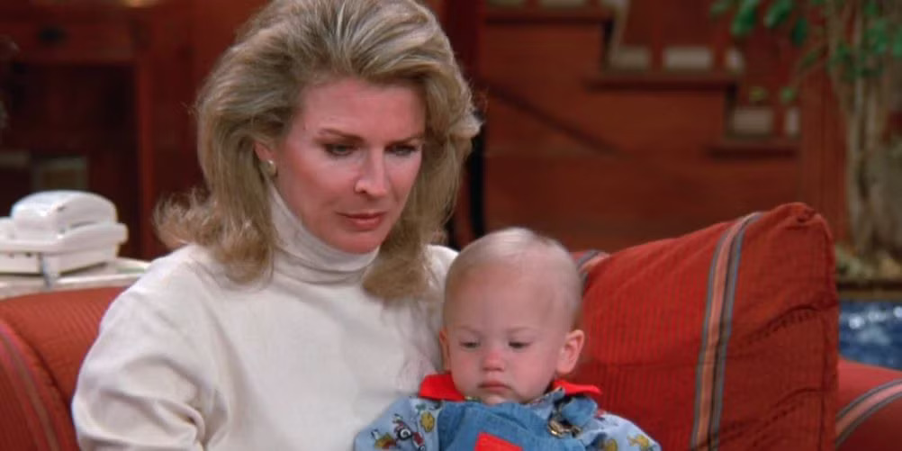 Murphy Brown (Candice Bergen) holds baby son Avery (Haley Joel Osment) in the 1980s sitcom.