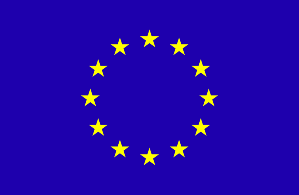 The EU flag, a circle of yellow stars on a blue background.